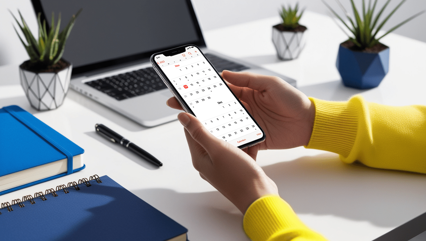 A person holding a phone looking at calendar