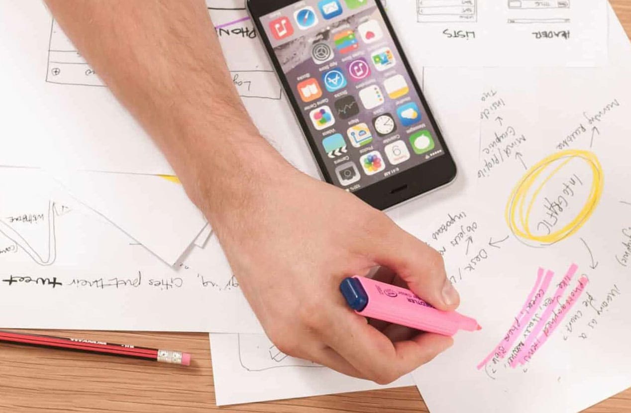 man creating a plan for website on paper