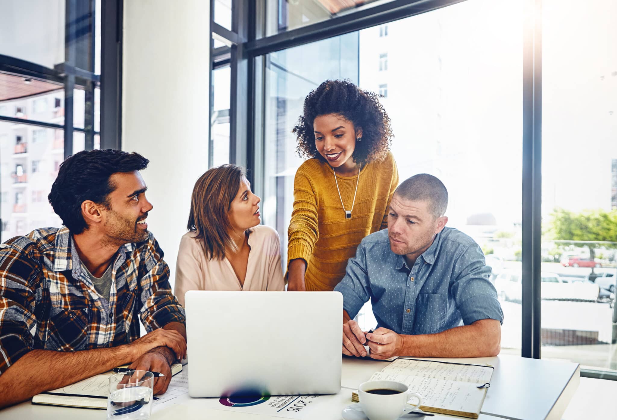 Business team reviewing strategy on laptop