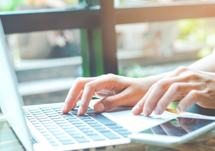 Women Using Online Communication on Laptop and Smartphone