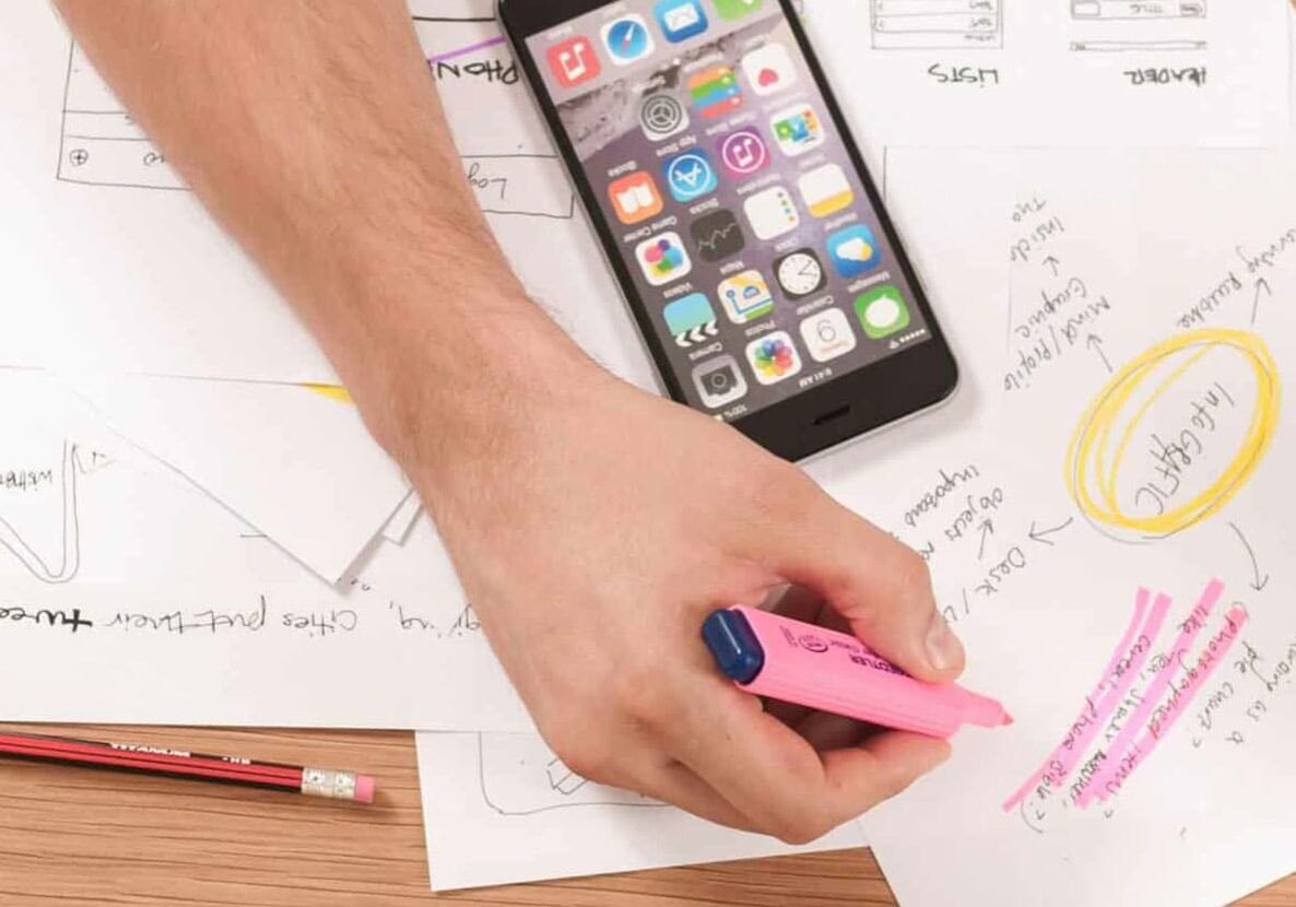 man creating a plan for website on paper