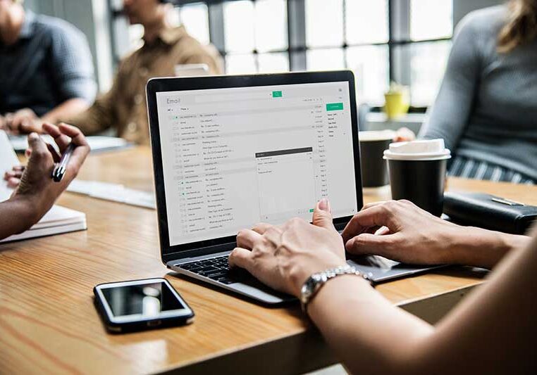 Woman Checking Email On Laptop at work