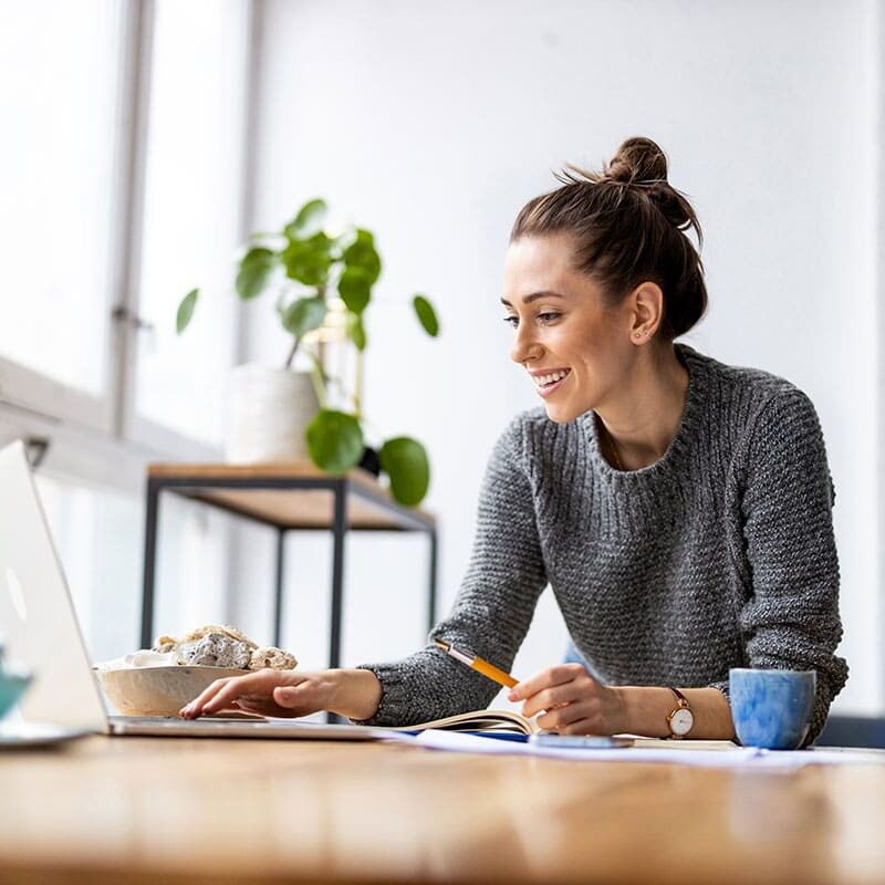 woman watching laptop at table
