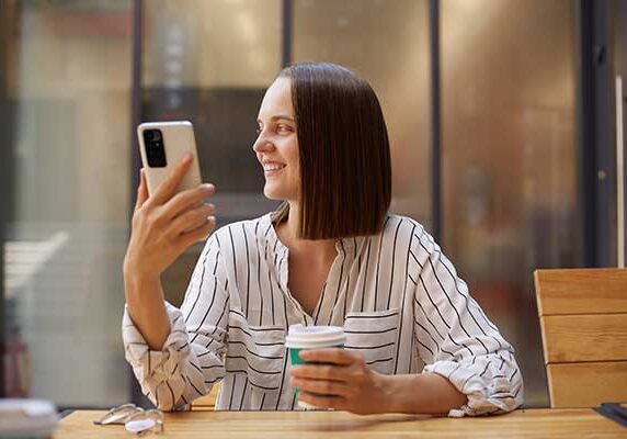 Women Enjoying Website On Mobile Device