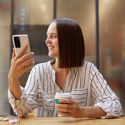 Women Enjoying Website On Mobile Device